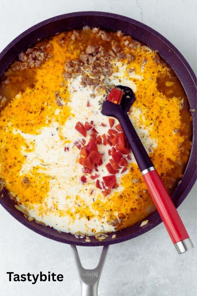 Adding broth, cream, and pepper