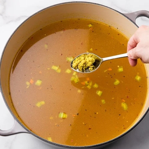 Adding broth to Chicken Noodle Soup